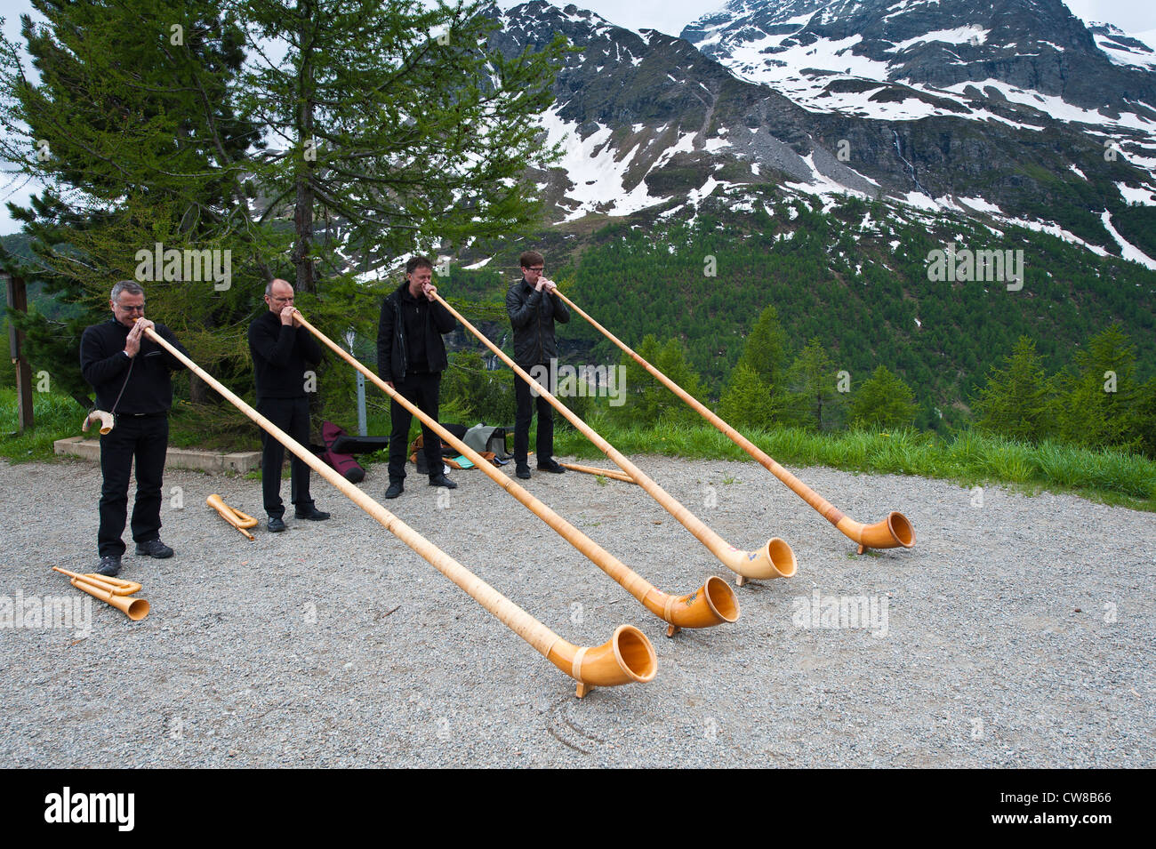 Men playing alpenhorn or alpine horn, Switzerland. Stock Photo