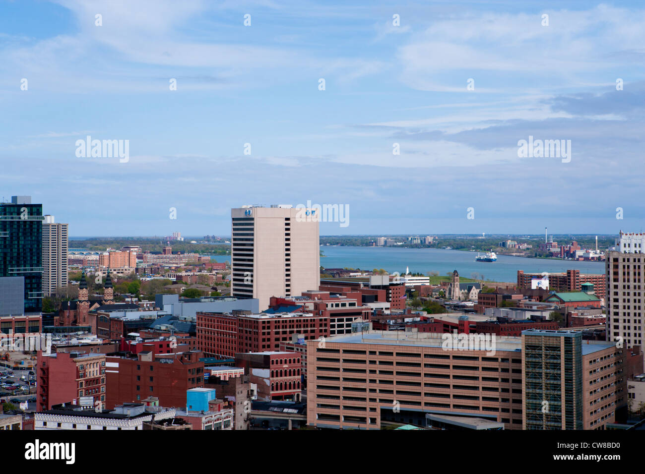 Detroit Michigan skyline looking towards the Detroit River which can be seen in the background a freighters heading upstream. Stock Photo