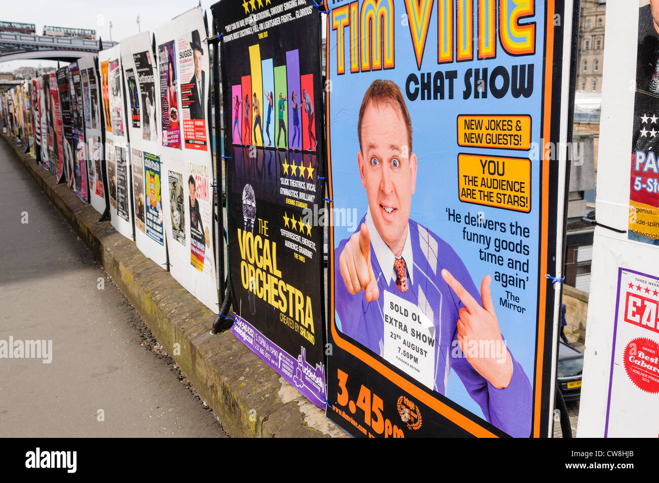 Lots of posters on a hoarding advertising for comedy and entertainment acts performing during the Edinburgh Fringe Festival Stock Photo
