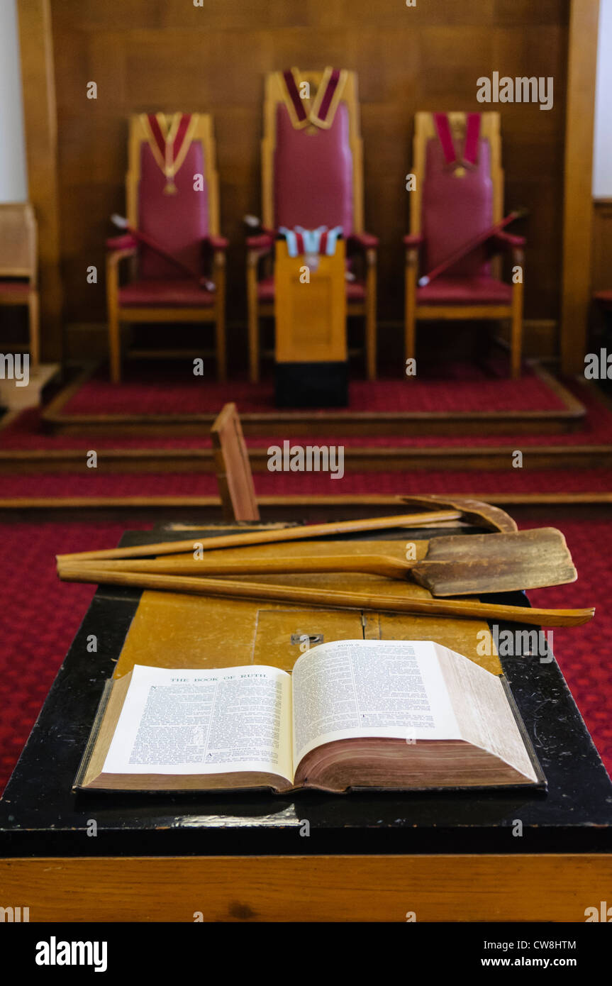 Bible and symbolic tools on the altar in a red Royal Arch Chapter masonic lodge room Stock Photo