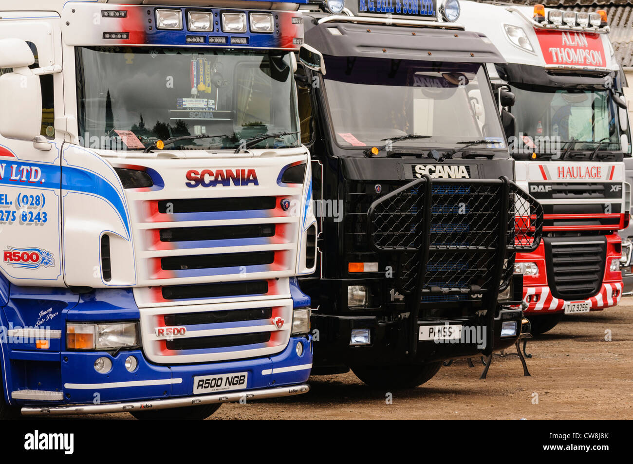 Two Scania R500 lorries/trucks and one DAF XF lorry parked up in a row Stock Photo