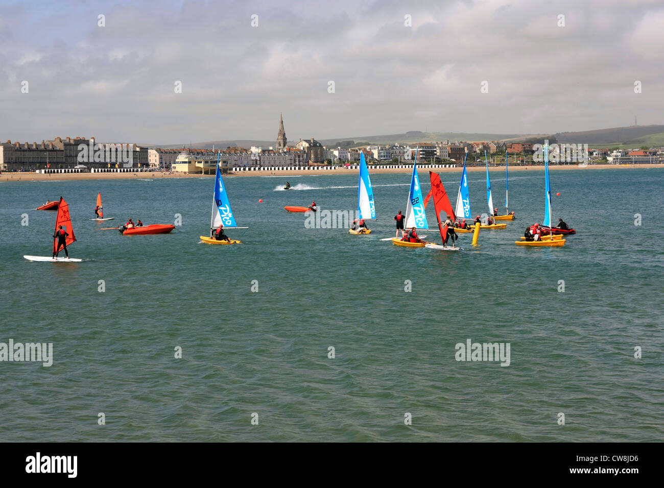 Small sailing boats in Weymouth bay part of Team Dorset Challenge to
