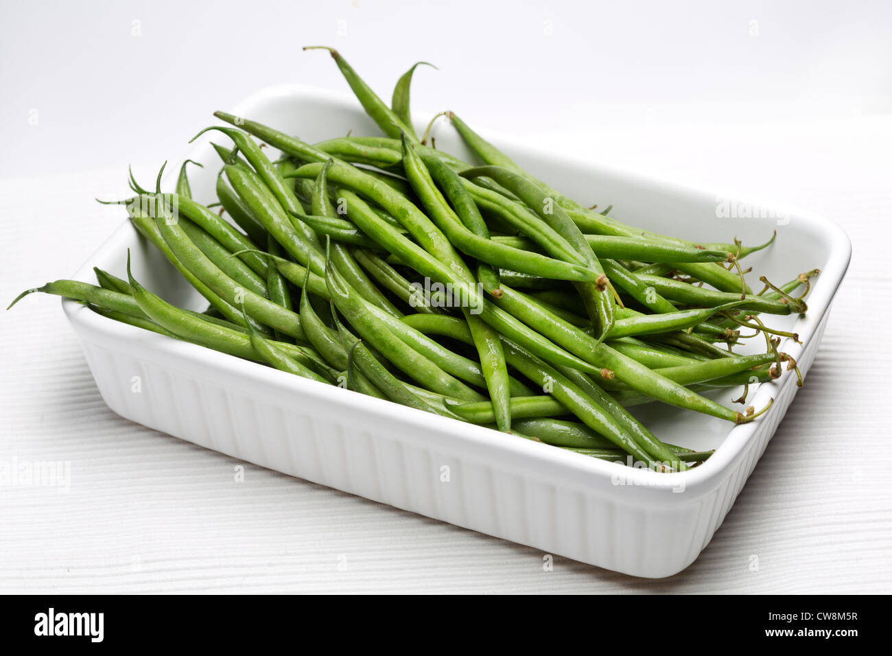 Green Beans in a white dish on a white background Stock Photo