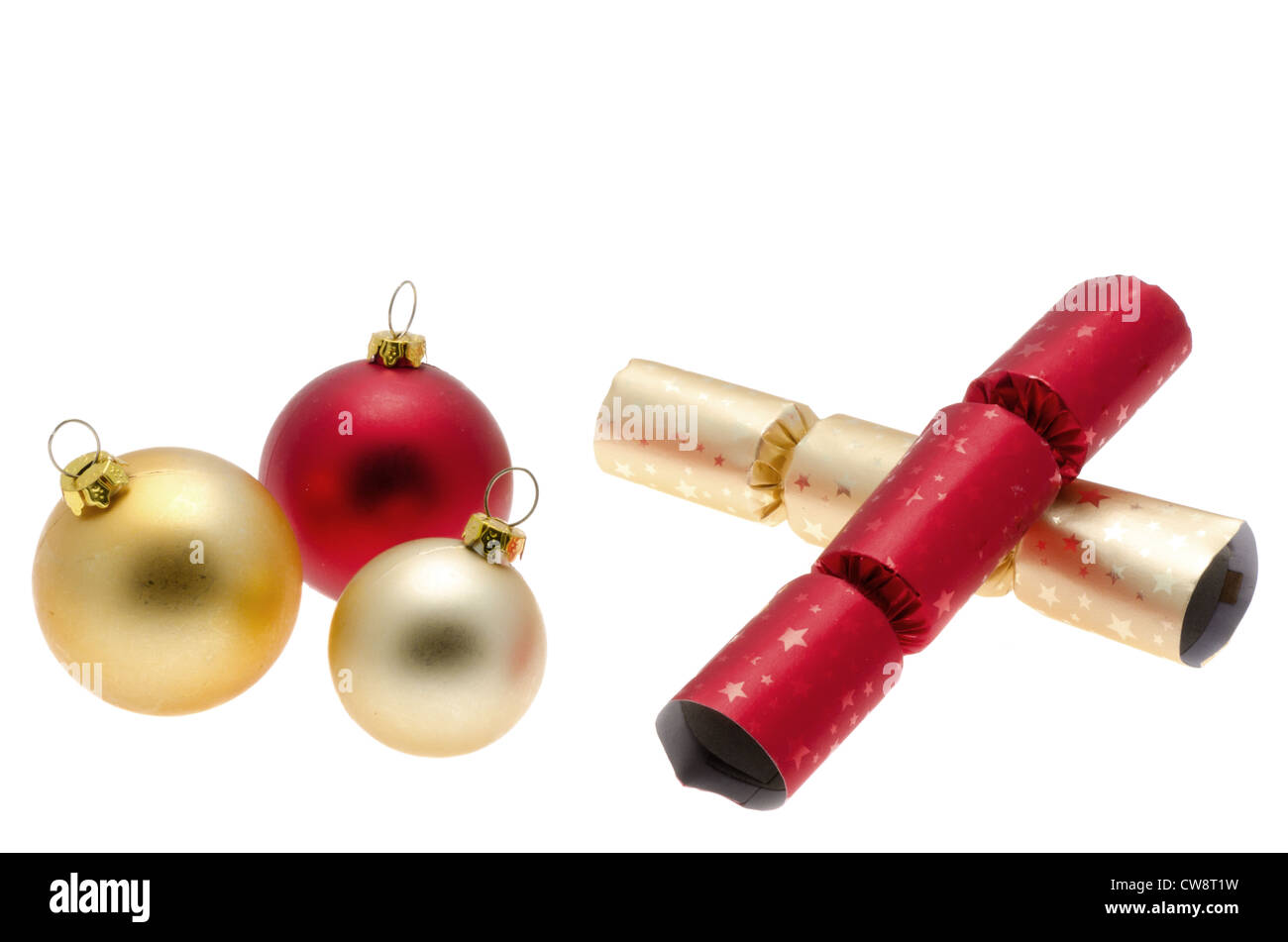 Christmas crackers and tree baubles - studio shot with a white background Stock Photo