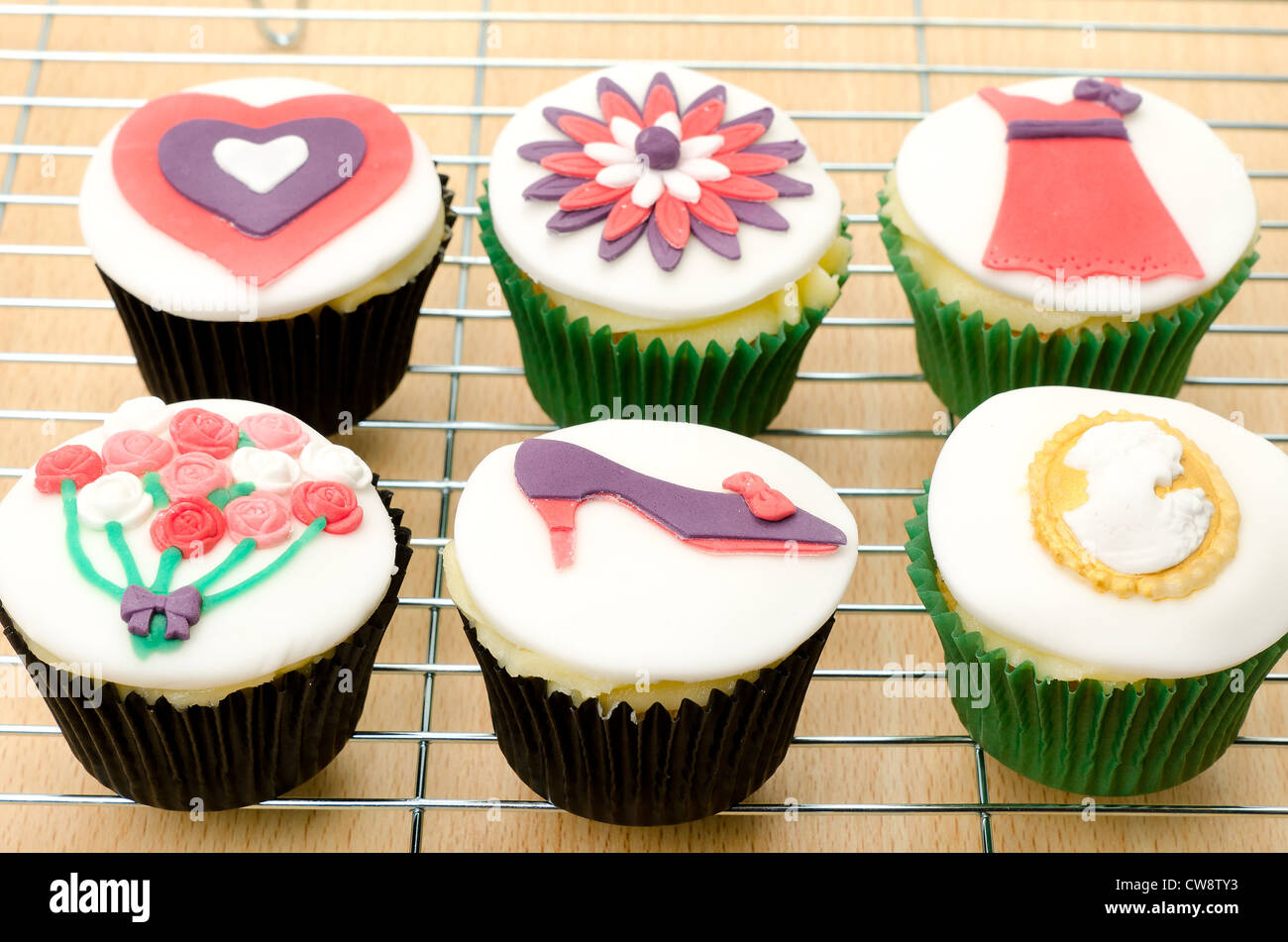 Six fresh cupcakes with different designs - shallow depth of field Stock Photo