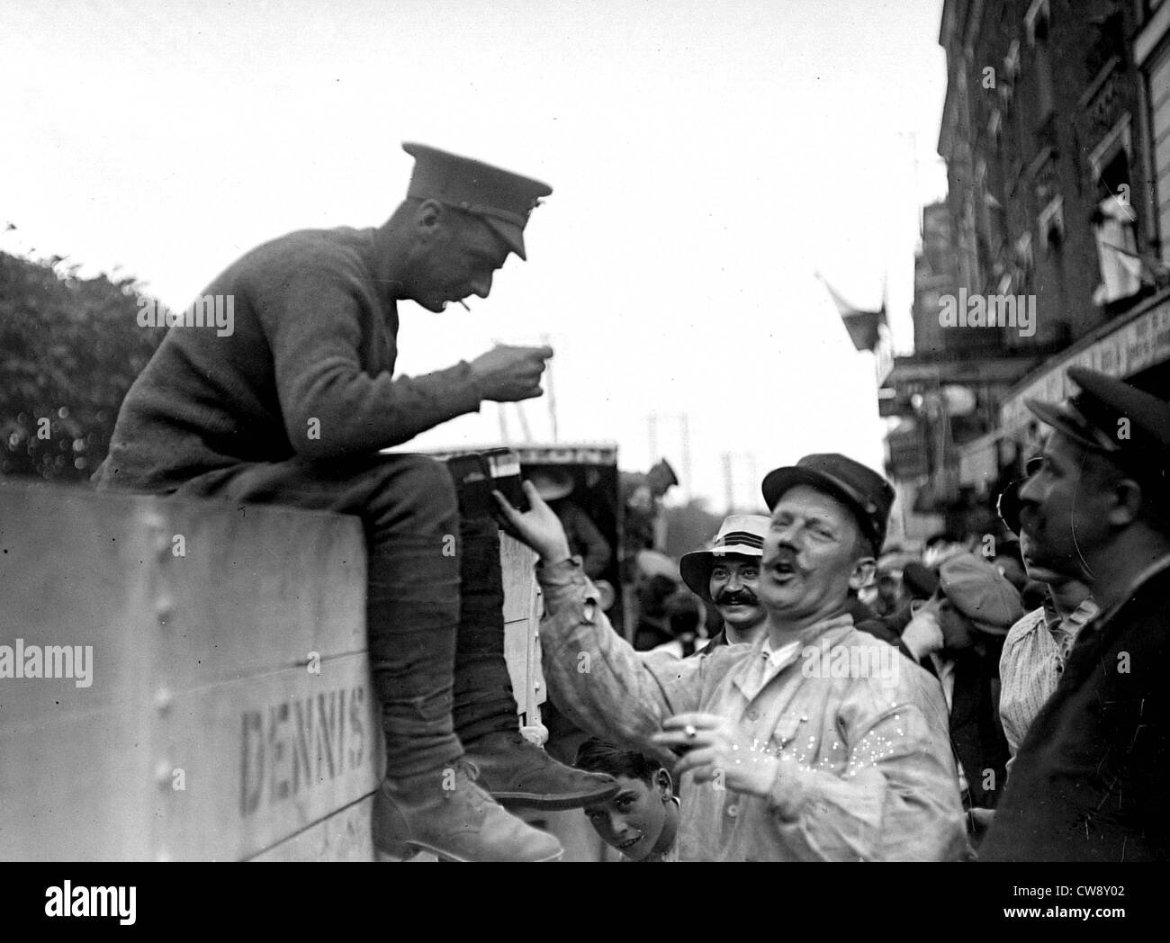 A soldier in French Territorial Army offers cigarettes to English soldier Stock Photo