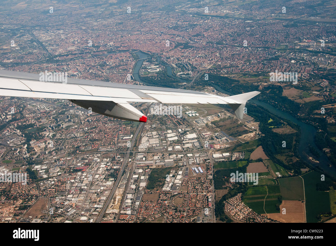 Airbus A319 aircraft wing turning over Toulouse southwest France Stock Photo