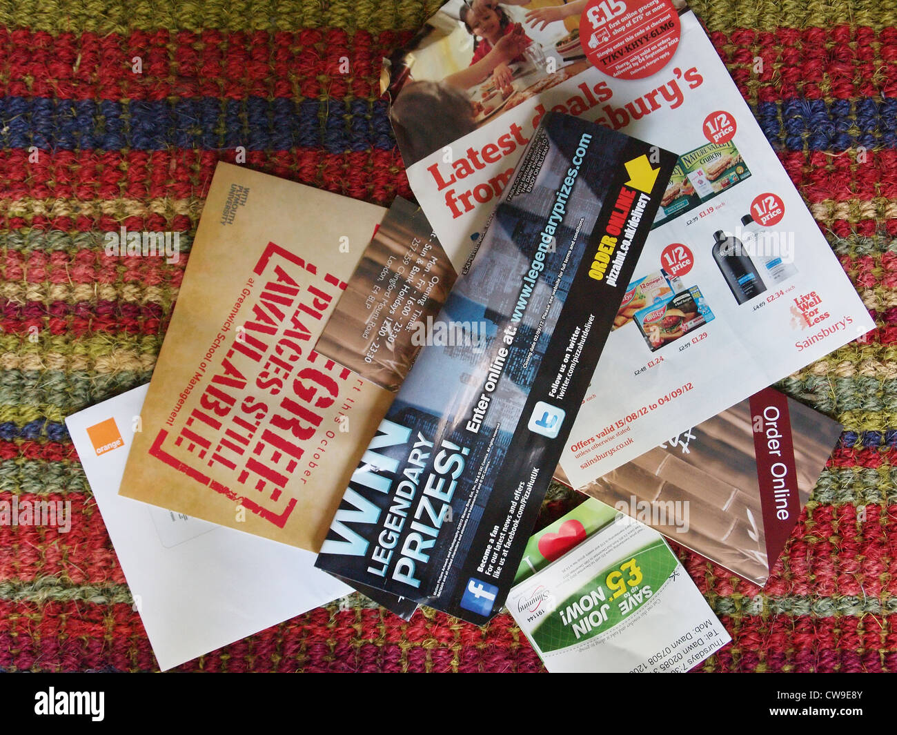 Junk mail sitting on a doormat in Britain Stock Photo