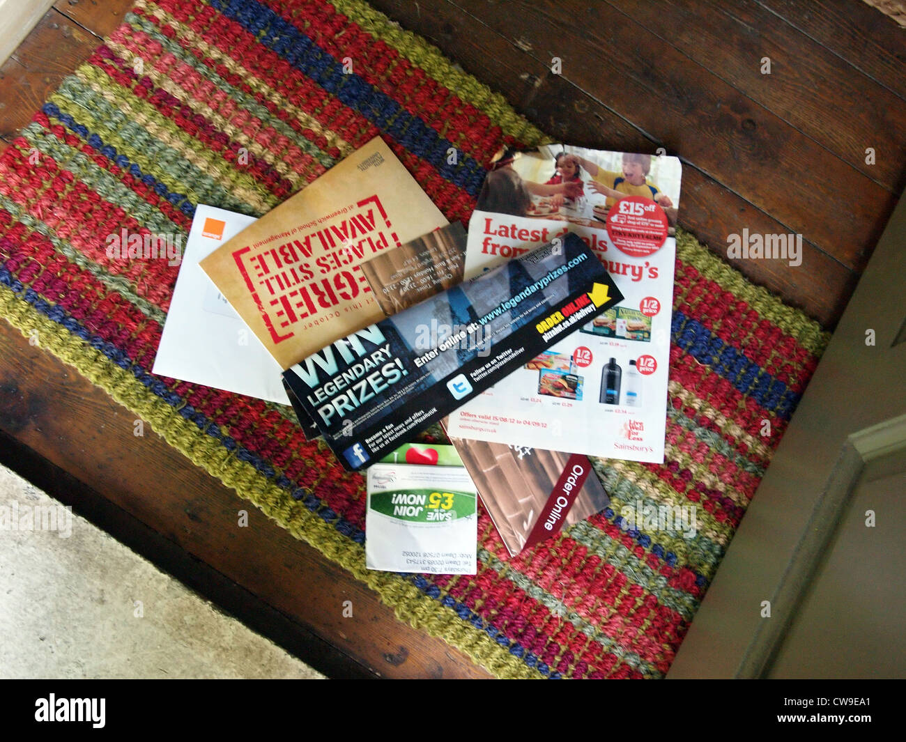 Junk mail sitting on a doormat in Britain Stock Photo