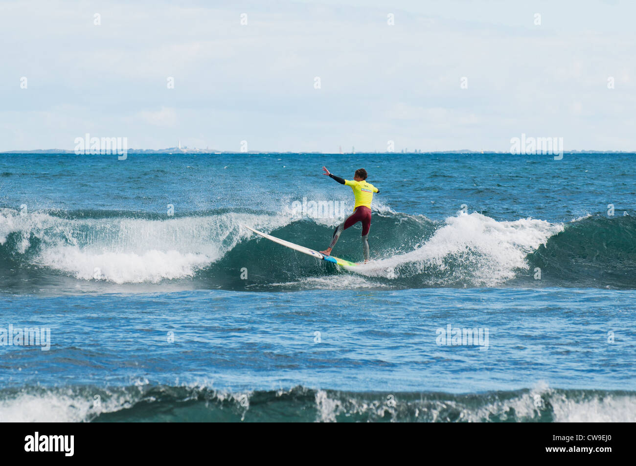 A surfer on a longboard at Isolators Reef in Western Australia. Stock Photo