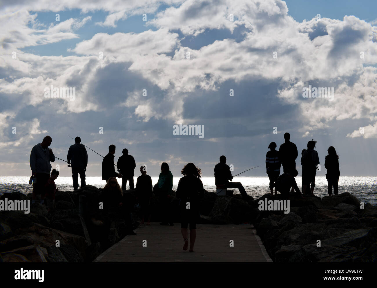 Perth Western Australia - Tourists and anglers standing on a breakwater on Cottesloe Beach in Perth, Western Australia Stock Photo