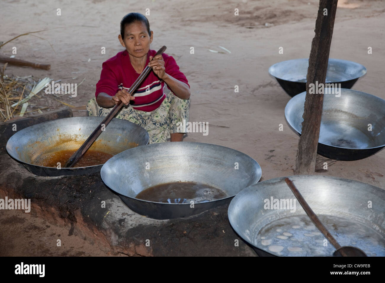 Myanmar, Burma, near Bagan. Heating Toddy Palm Juice to Make Sugar. Stock Photo