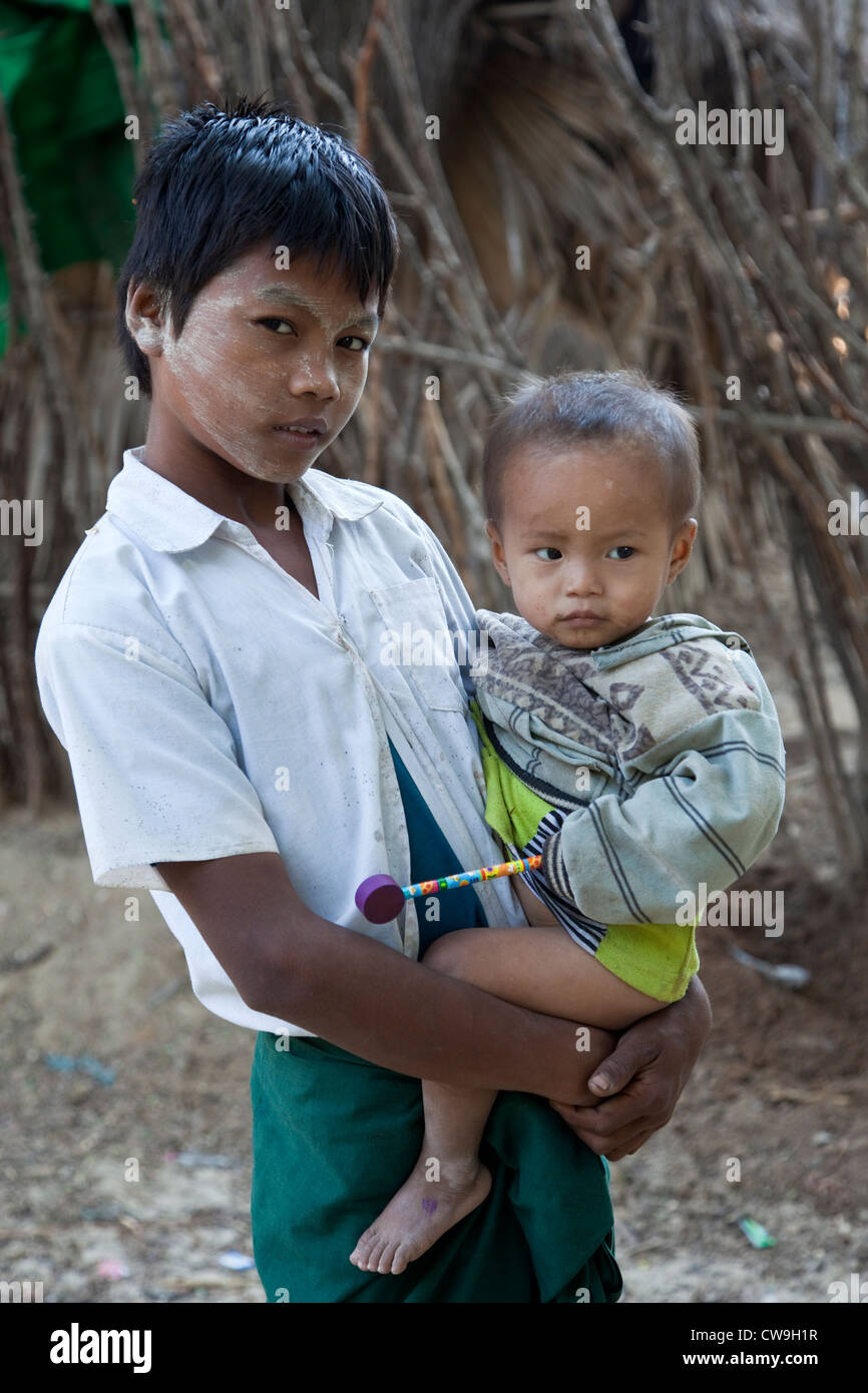 Myanmar, Burma. Two Boys in a Burmese Village near Bagan. The older boy has thanaka paste on his face, a cosmetic sunscreen. Stock Photo