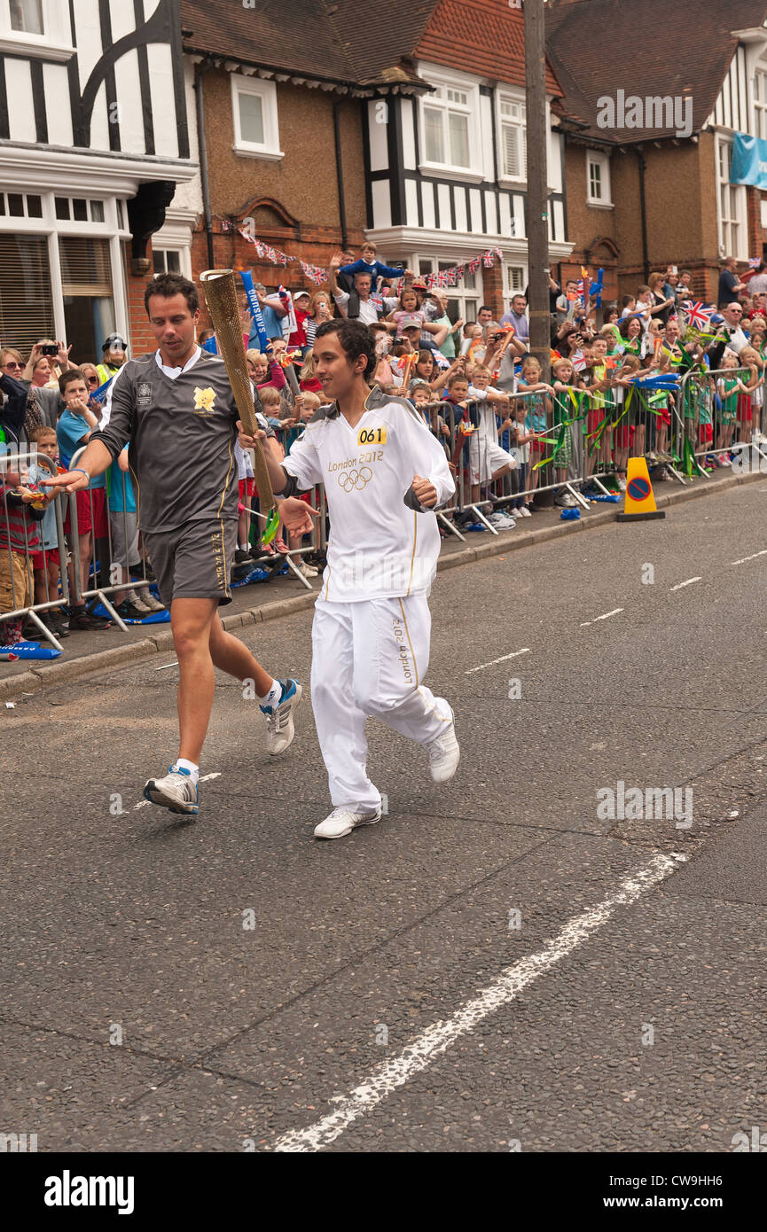 Olympic games touch bearer relay and associated authorities in a procession High Street Seal with awaiting crowds Stock Photo