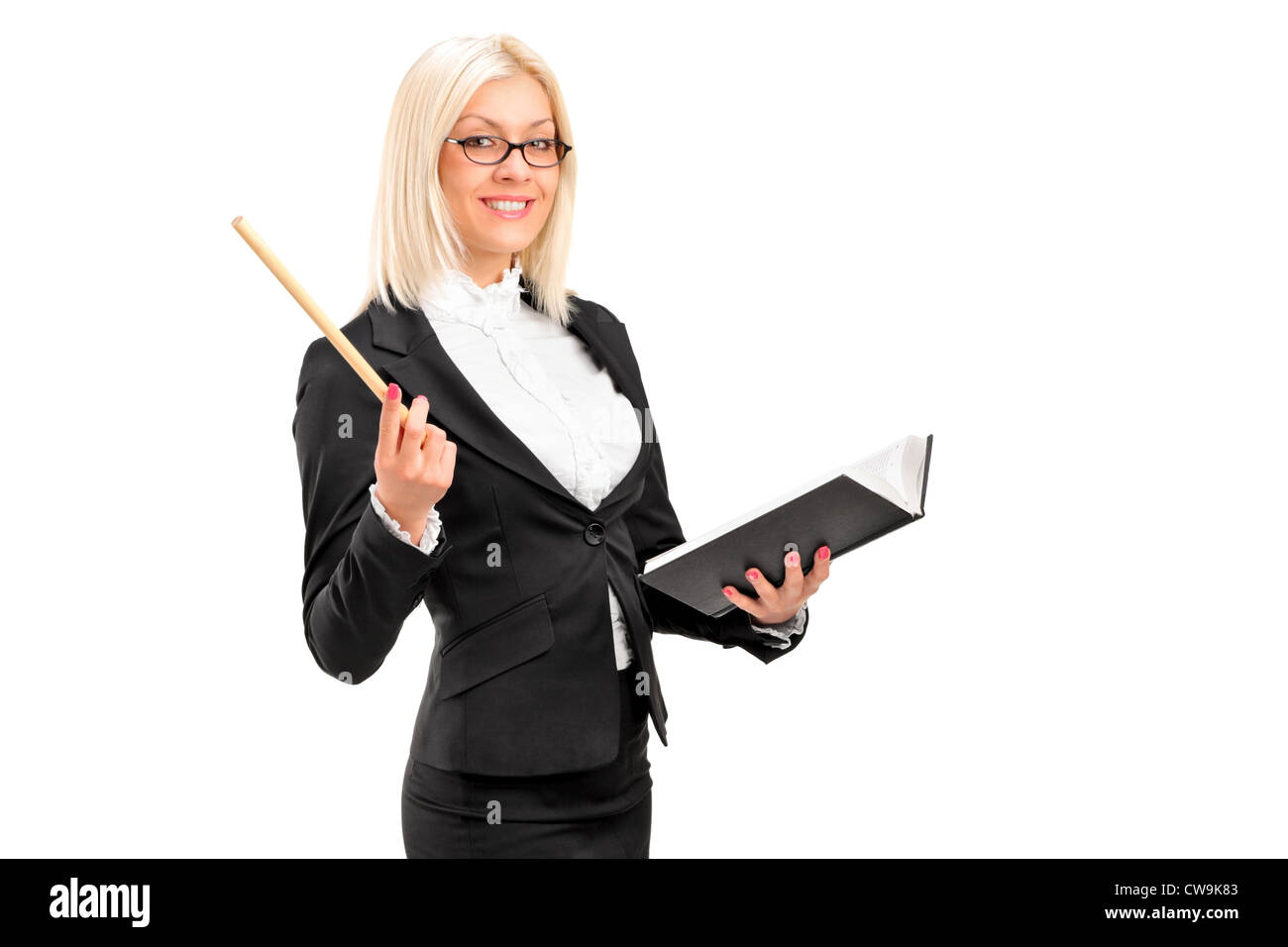 A female teacher posing with a book in her hand isolated on white ...