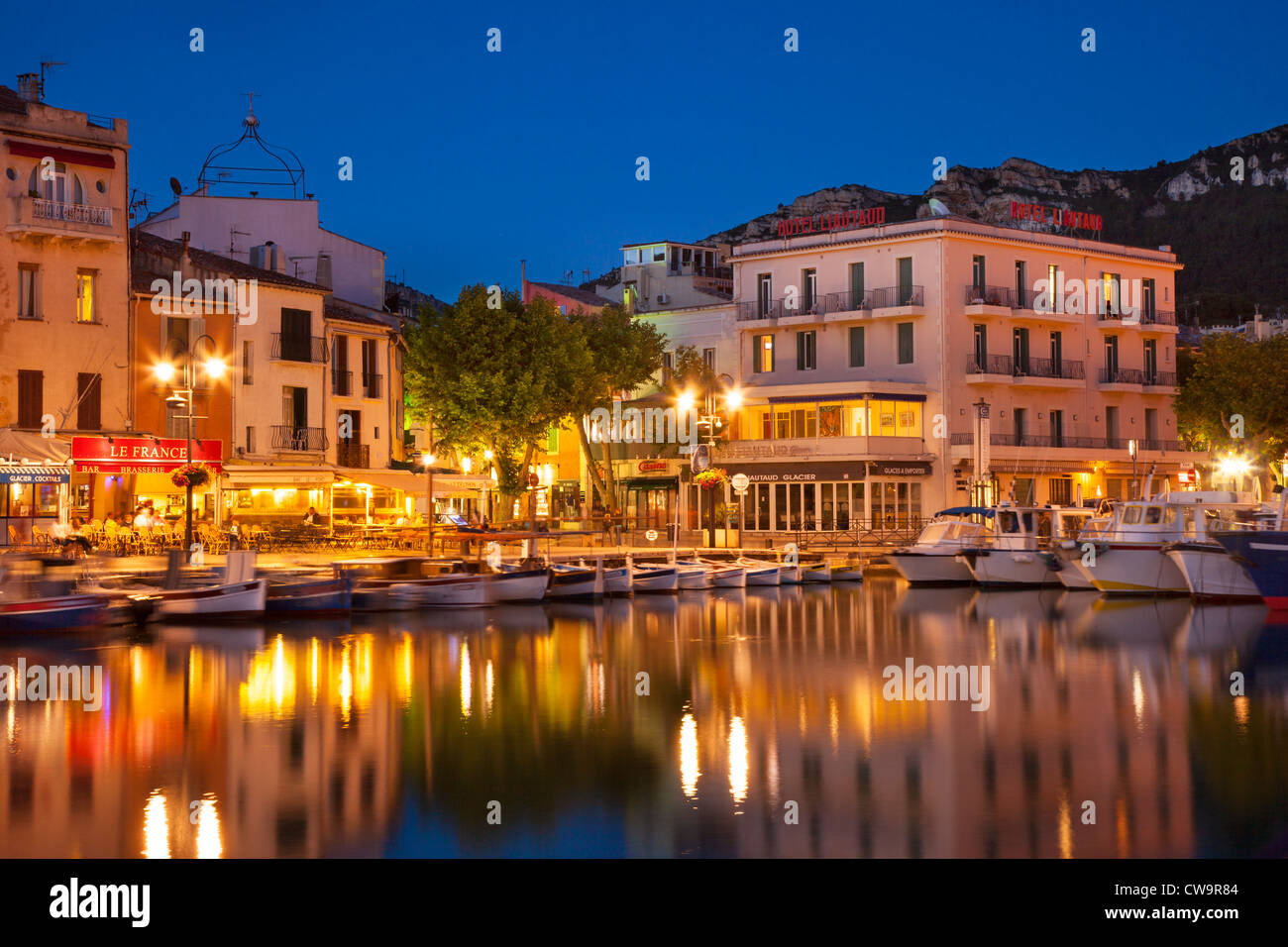 Twilight over the harbor town of Cassis along the Cote d'Azur, Bouches ...