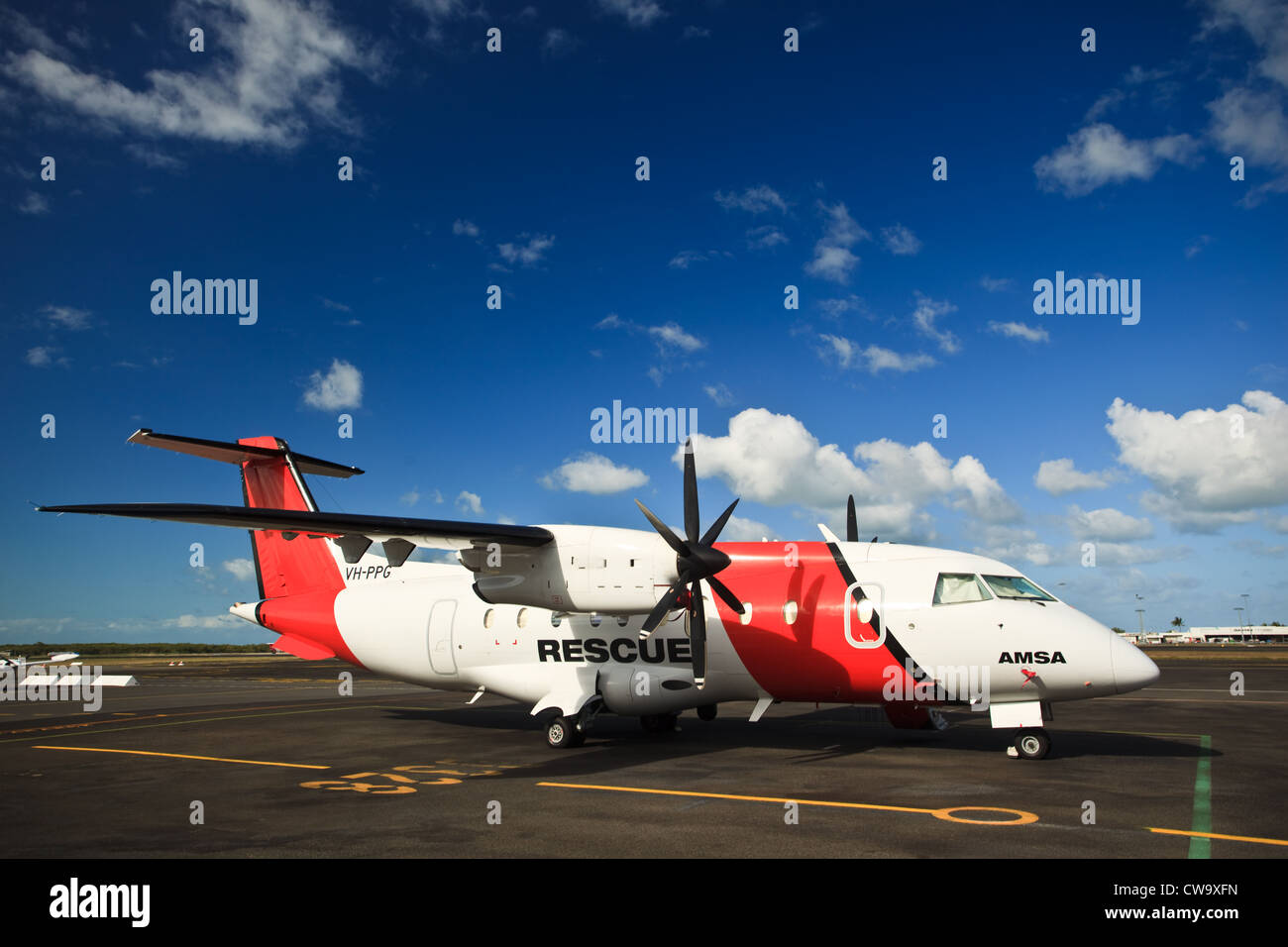 Closeup of Coastguard rescue plane waiting on runway for mission at Cairns airport in Queensland Australia on a sunny day Stock Photo