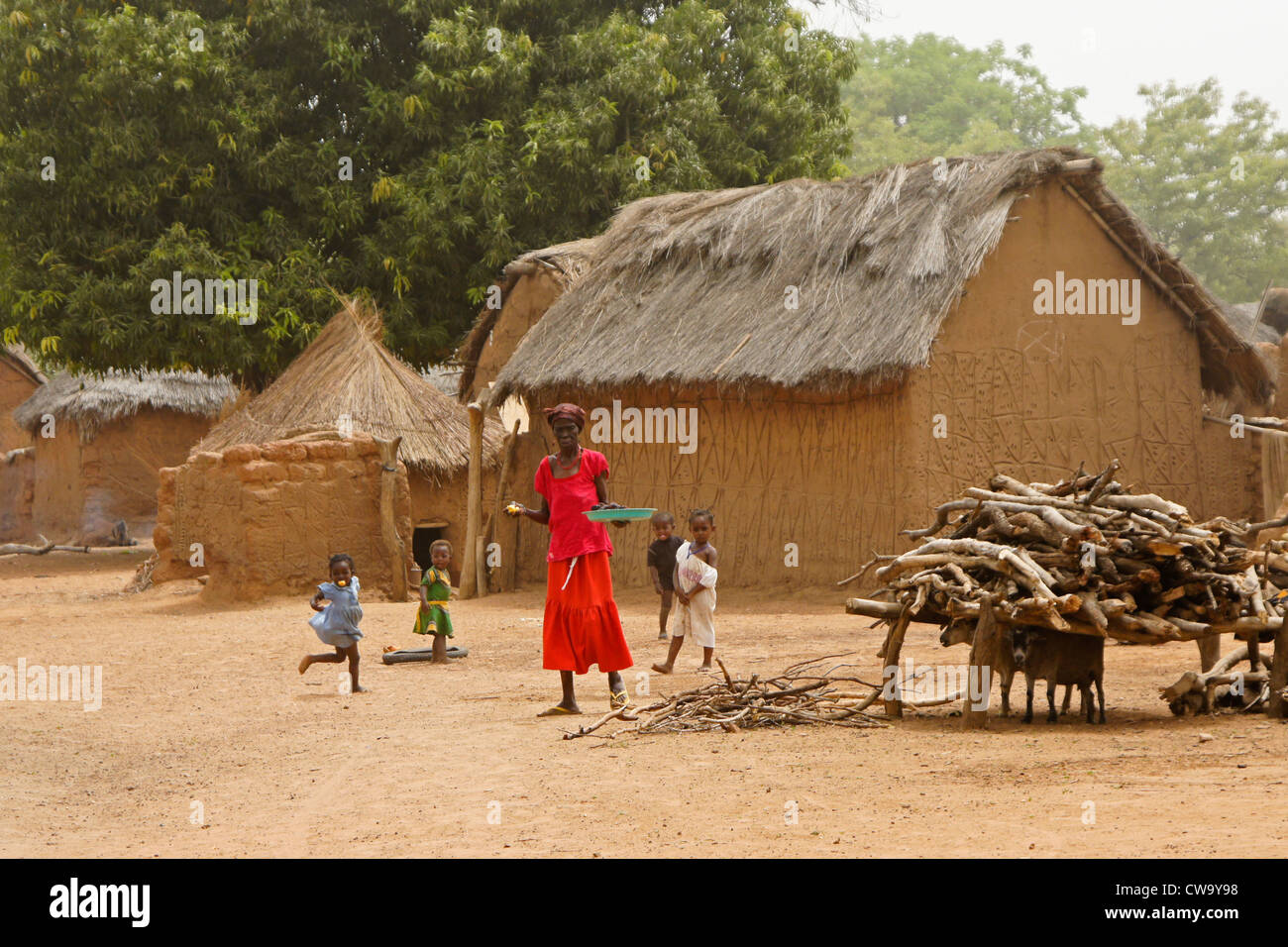 Thatched mud houses and people of Mognori Eco-Village, Ghana Stock Photo
