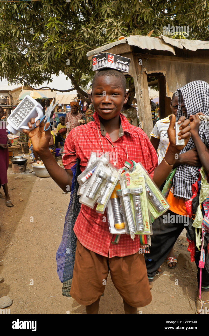 Boy selling flashlights and batteries in market, Sirigu, Ghana Stock Photo