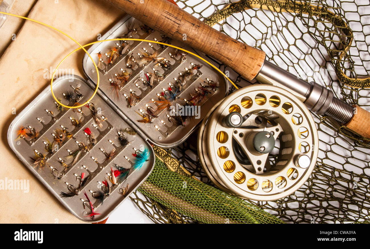 Still life of fly fishing rod, reel, fly box next and fishing bag