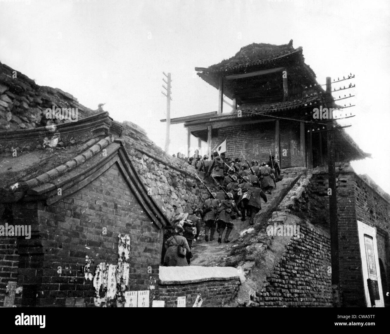 JAPANESE CLIMB CHINESE WALL  Photo, taken in Manchuria, shows Japanese infantry swarming up the steps of the main entrance to Stock Photo