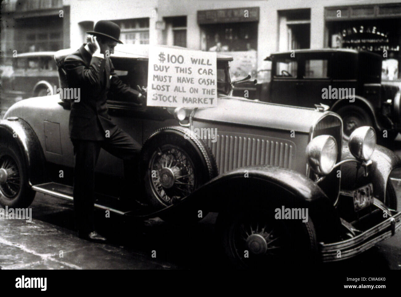 Man trying to sell his expensive car for $100 after being wiped out in the Stock Market Crash, 1929.. Courtesy: CSU Archives / Stock Photo