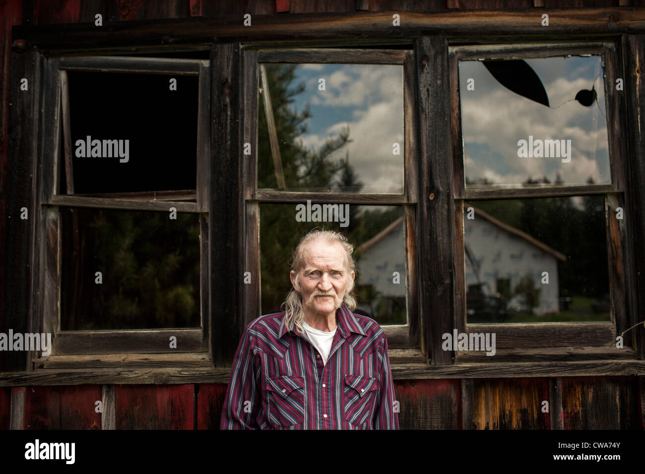 Senior man outside shack, portrait Stock Photo