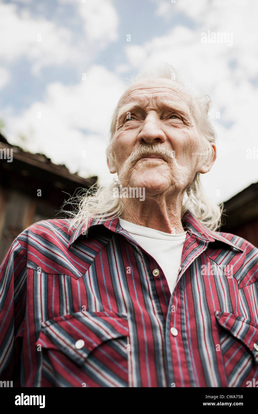 Senior man with long grey hair, portrait Stock Photo