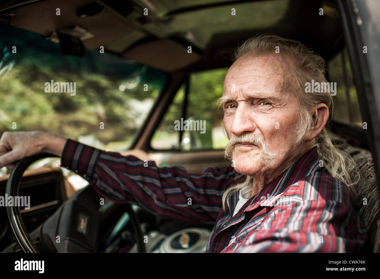 Senior man inside car Stock Photo