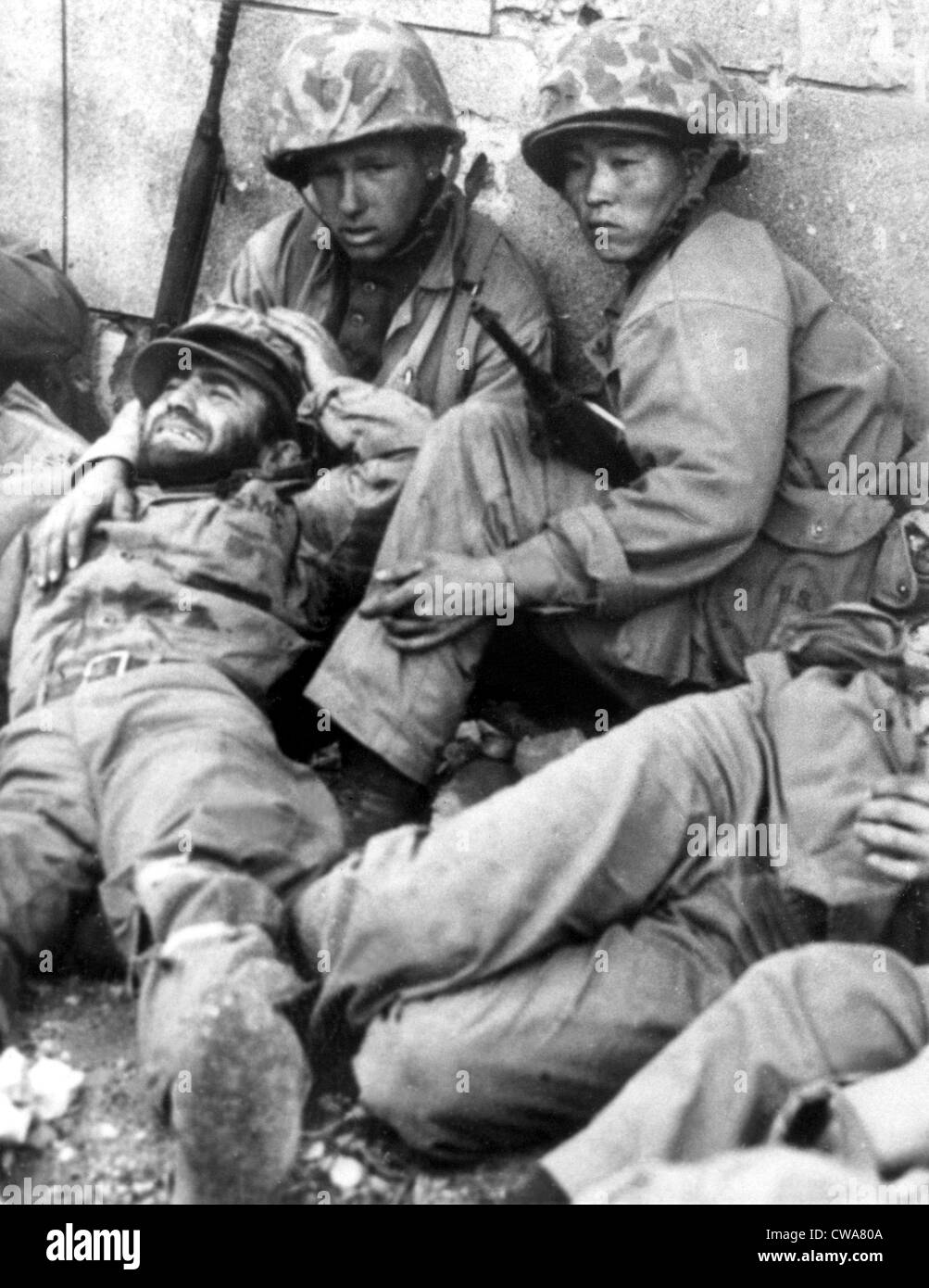 10/01/50--SOUTH KOREA: During heavy fighting, U.S. Marines snatch a moment's rest behind a wall in the streets of Seoul.. Stock Photo