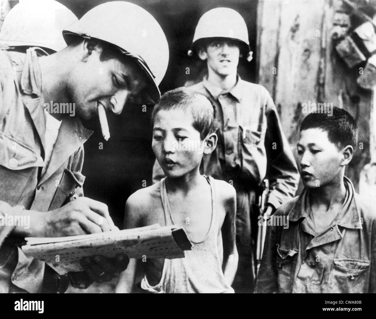 SOMEWHERE IN KOREA, 10/6/50: Two North Korean boys, serving in North Korean Army, are interrogated by a GI after their Stock Photo