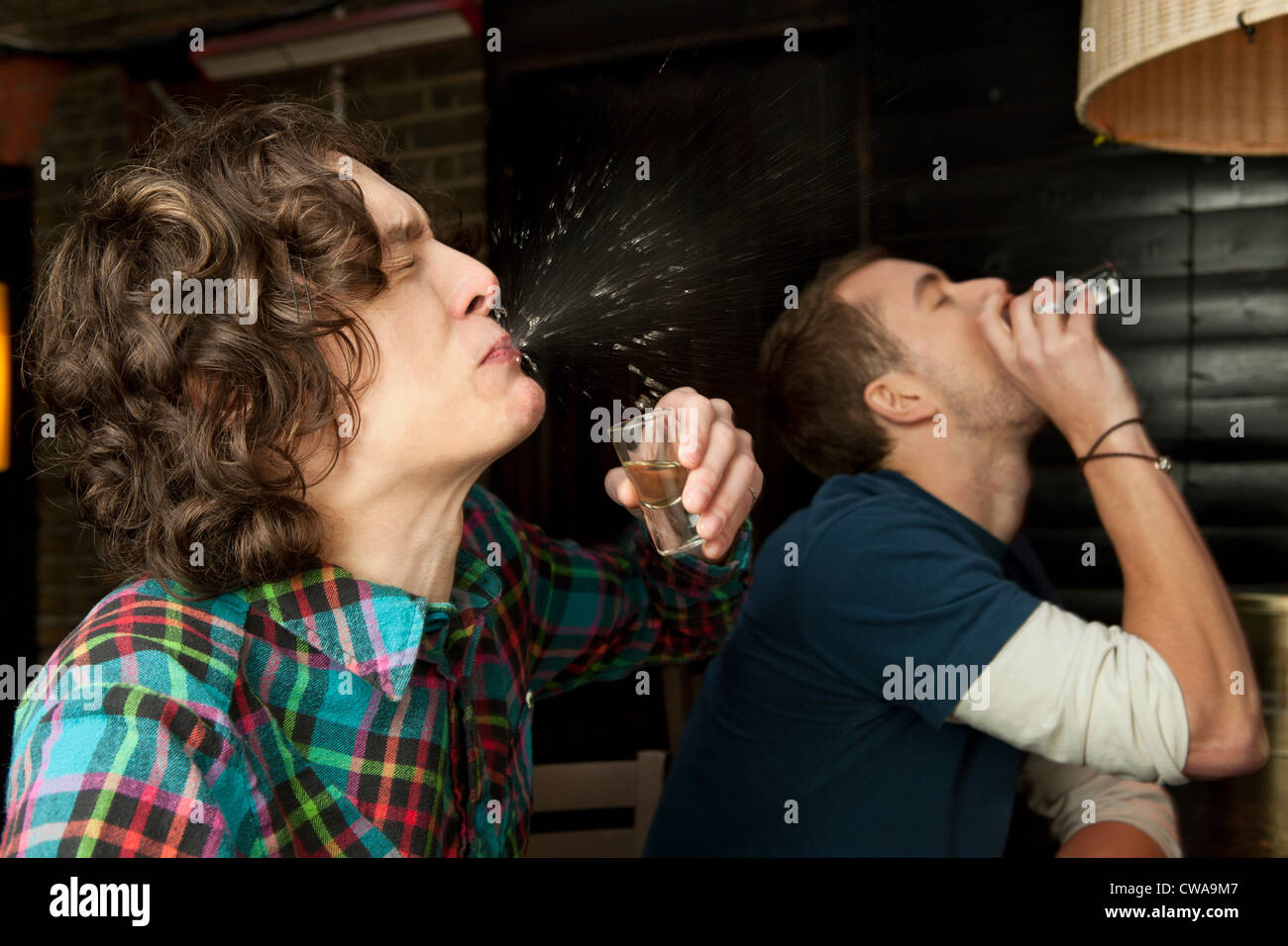 Two men drinking shots Stock Photo