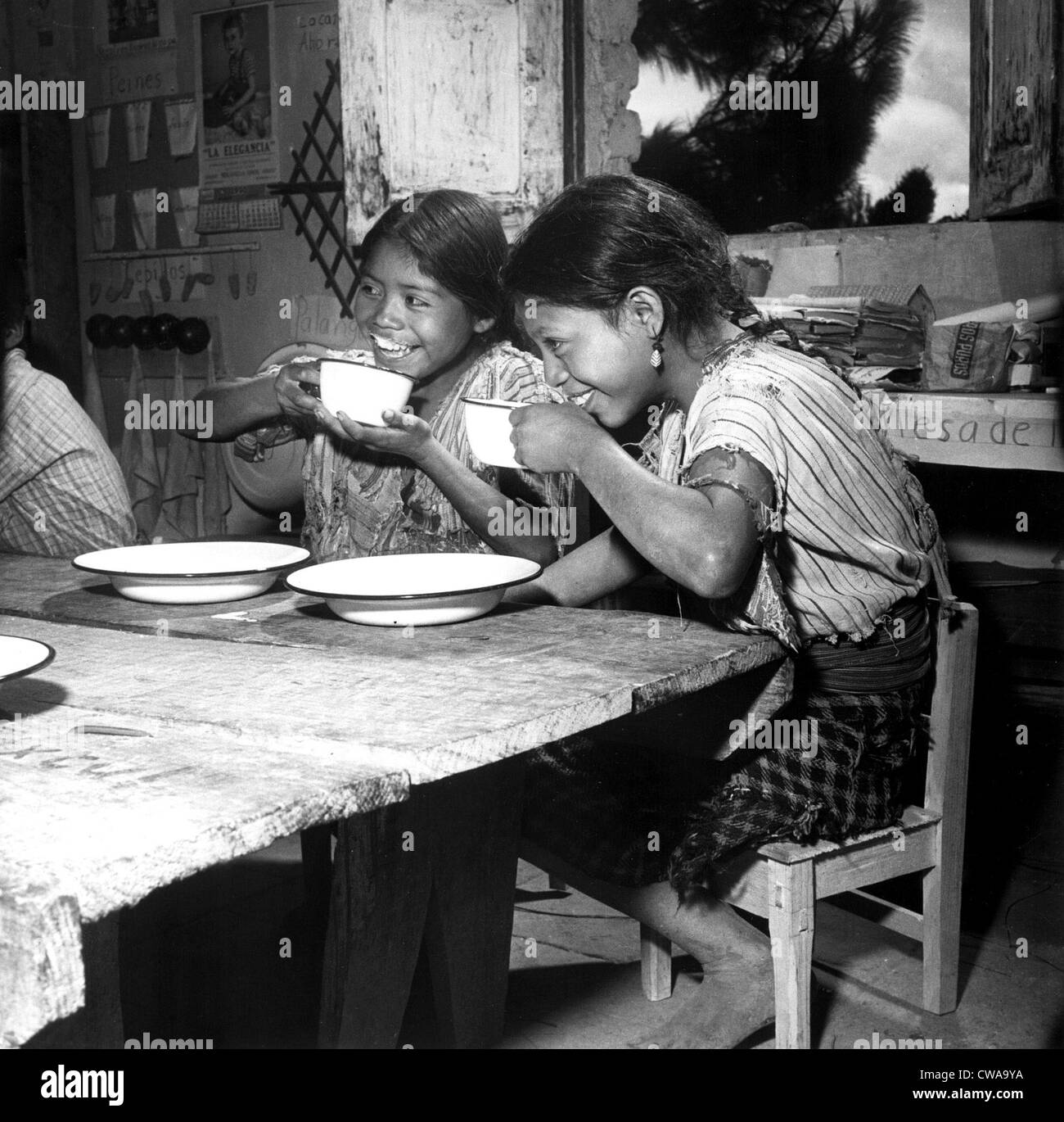 Children from a rural school nesar Lake Atitlan, in Guatemala, are shown enjoying their daily ration of milk, supplied by Stock Photo
