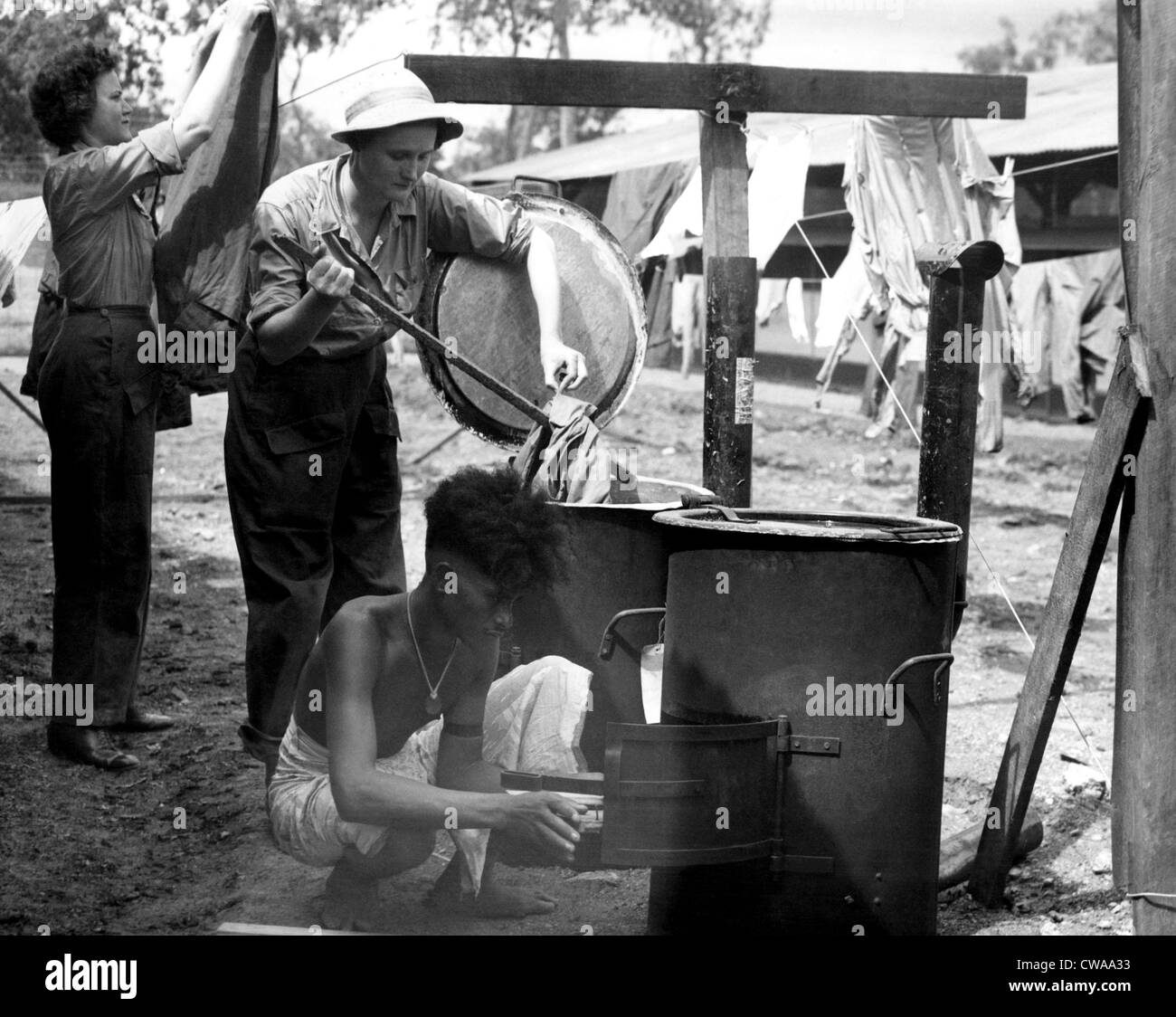 Doing the laundry in the 1960s. A lady is using a washboard to