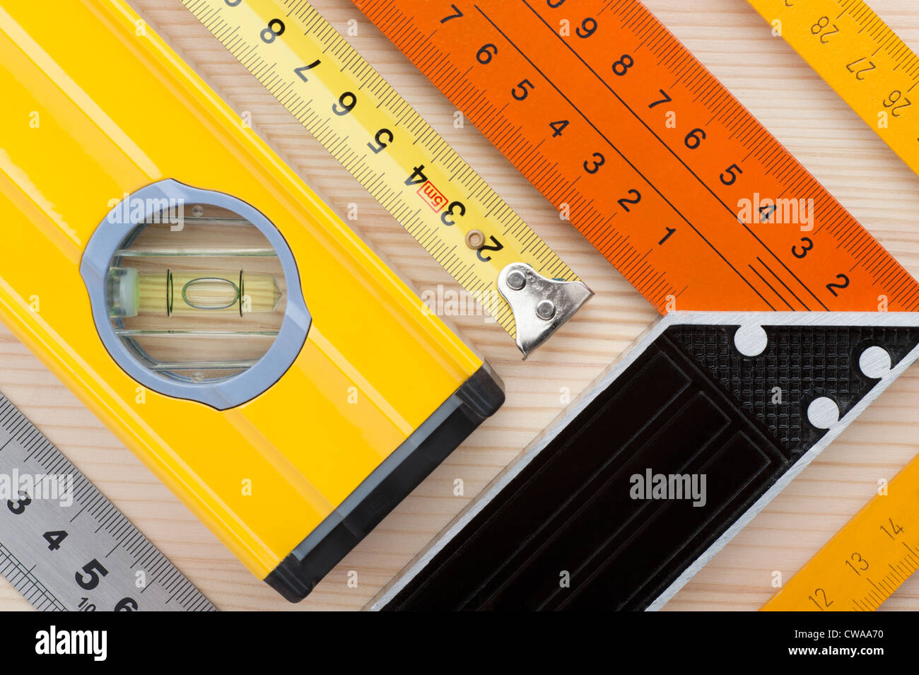 Assorted measurement tools, arranged on wooden surface, as an abstract background Stock Photo