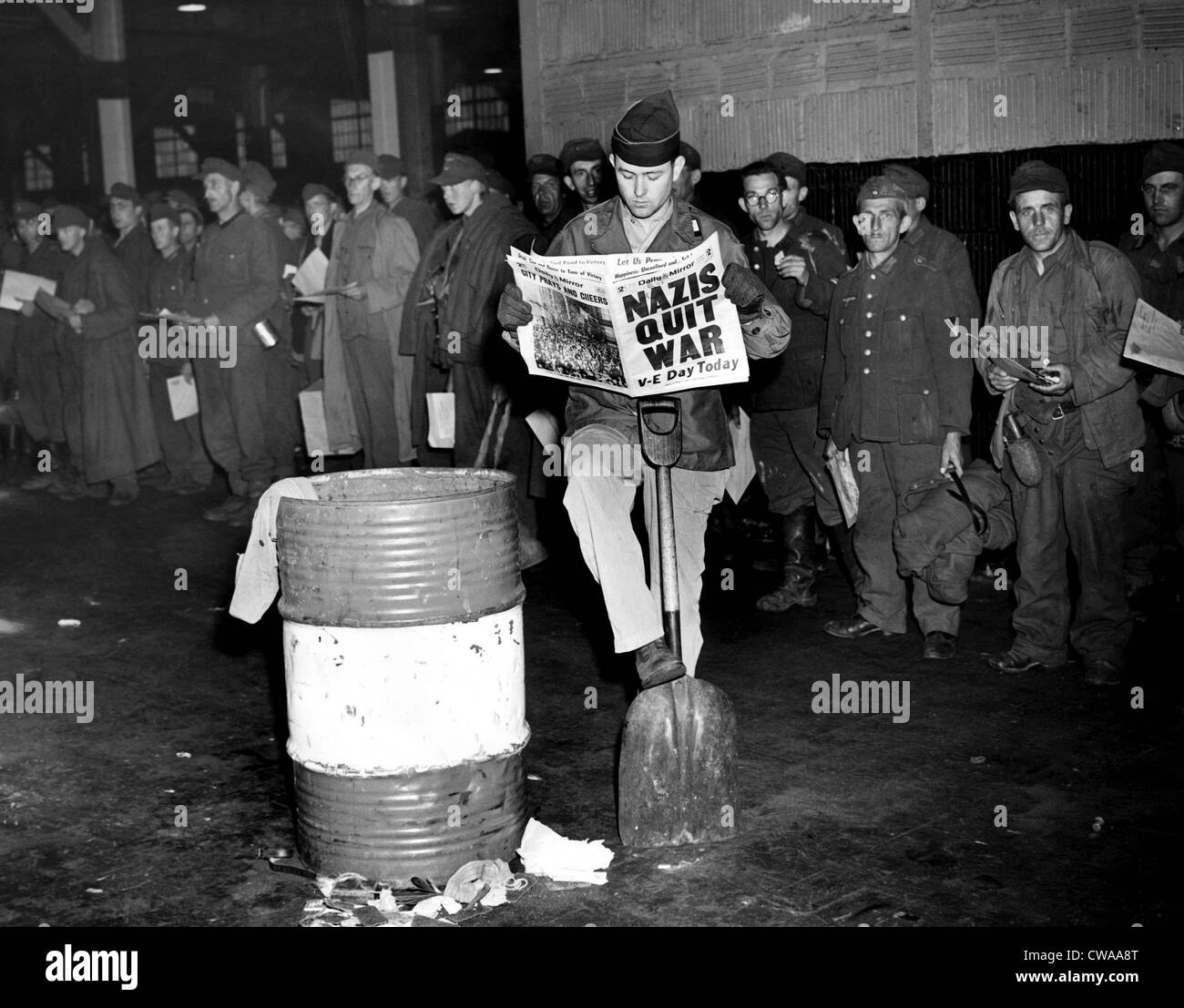 German prisoners of war in New York on the day Germany surrendered, ending the war in Europe. The newspaper headline reads: Stock Photo