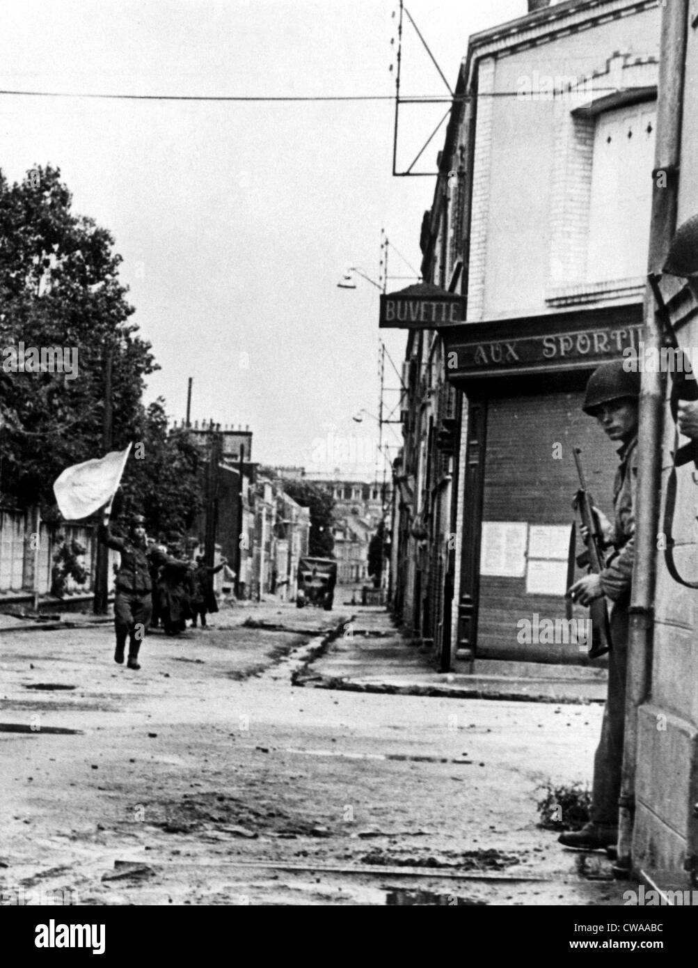 FRANCE--Defenders of a pillbox guarding a street in Cherbourg, German soldiers surrender, waving a white flag, after being Stock Photo