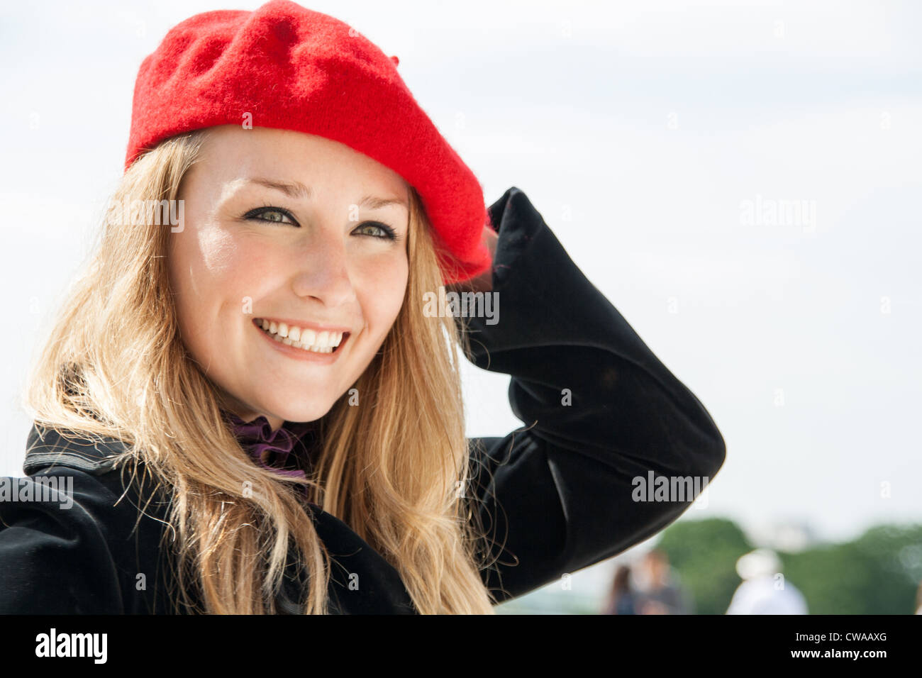 A Beautiful girl, wearing a red hat and smiling. Stock Photo