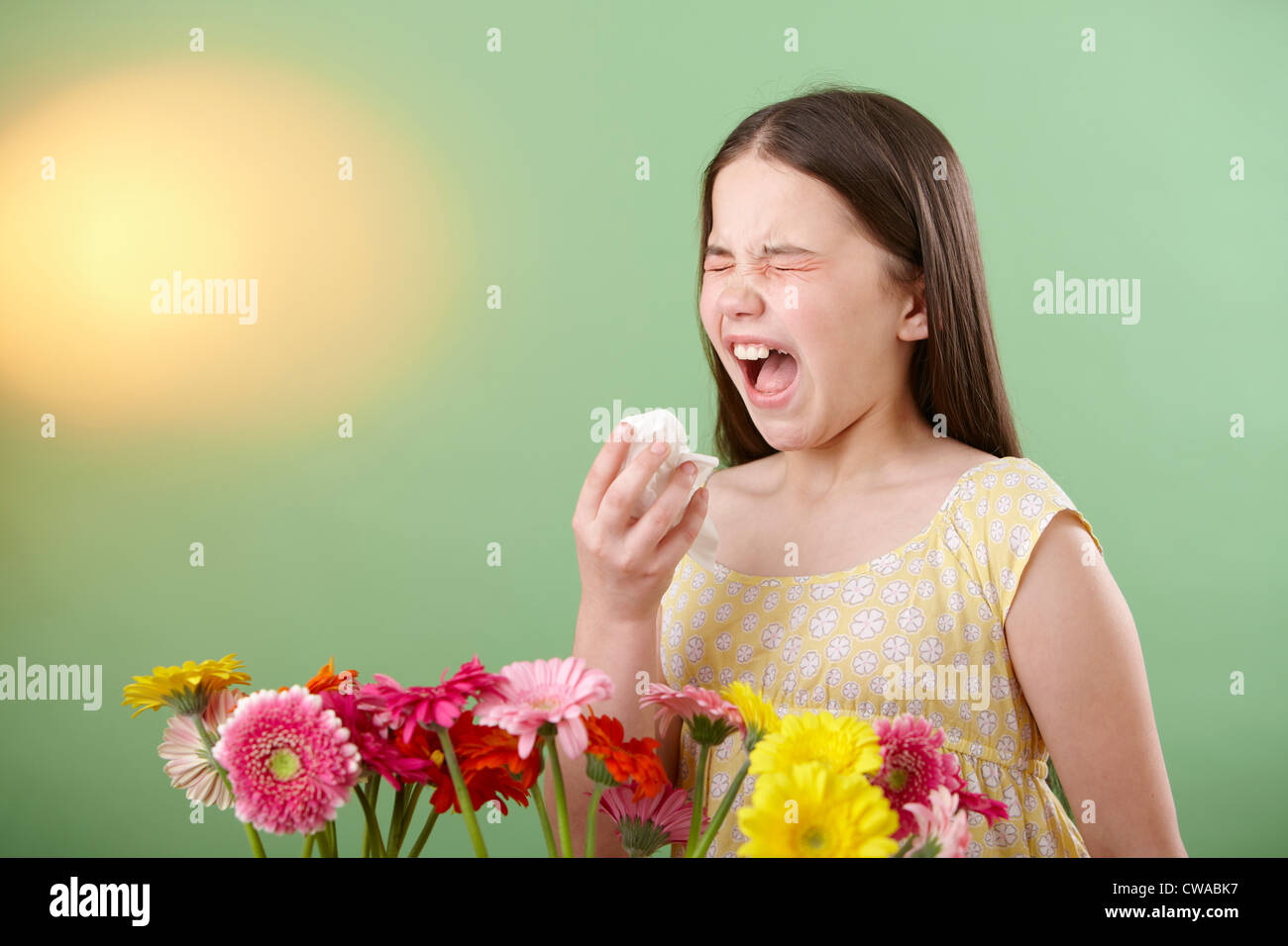 Girl with flowers sneezing Stock Photo