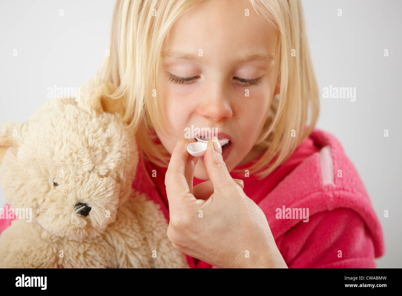 Parent giving daughter medicine Stock Photo Alamy