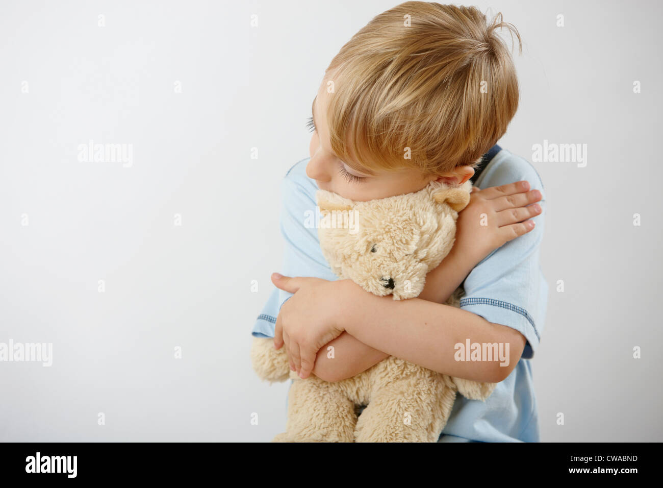 Boy hugging teddy Stock Photo - Alamy