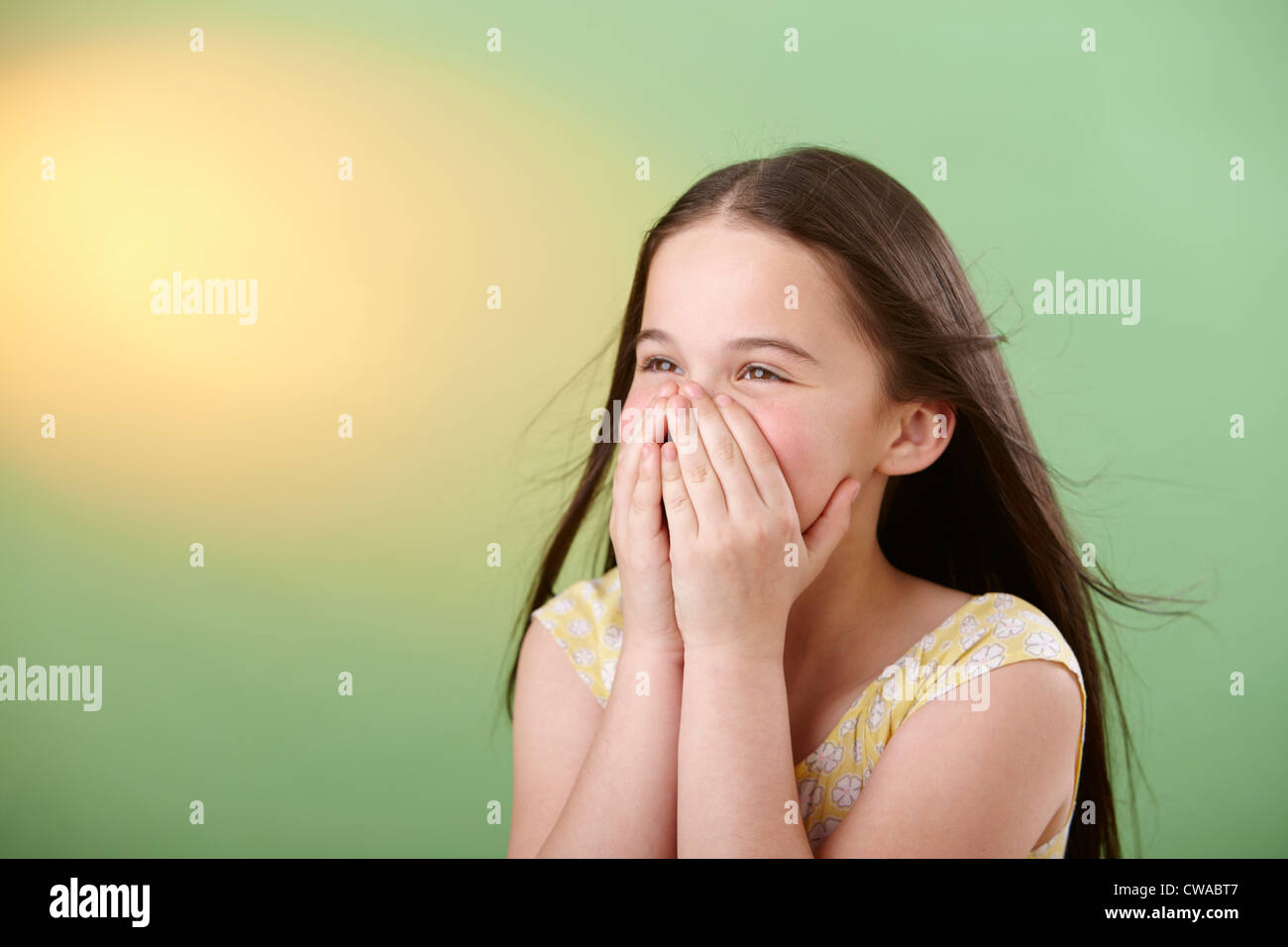 Girl covering mouth Stock Photo