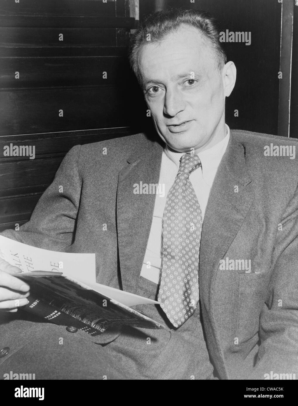 Nelson Algren (1909-1981), holding copy of his 1956 book 'A Walk on the Wild Side.' He won the National Book award for his 1949 Stock Photo