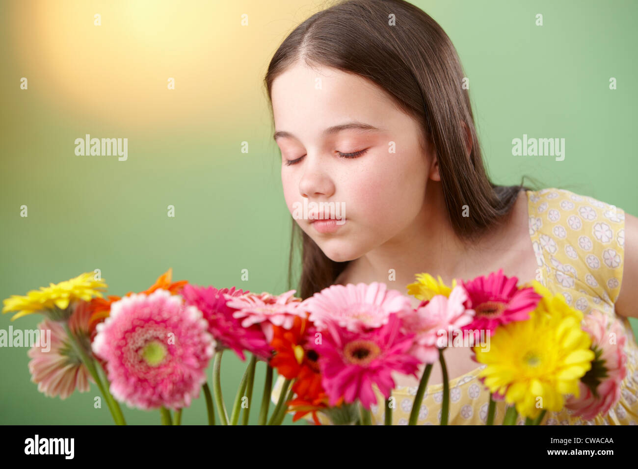 Girl sniffing flowers Stock Photo