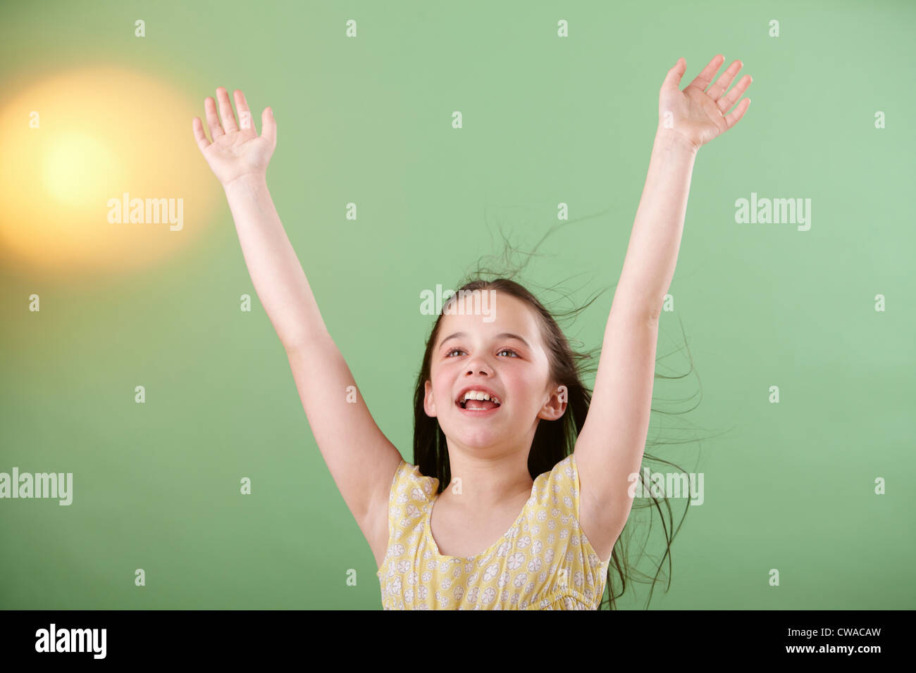 Girl with arms raised Stock Photo