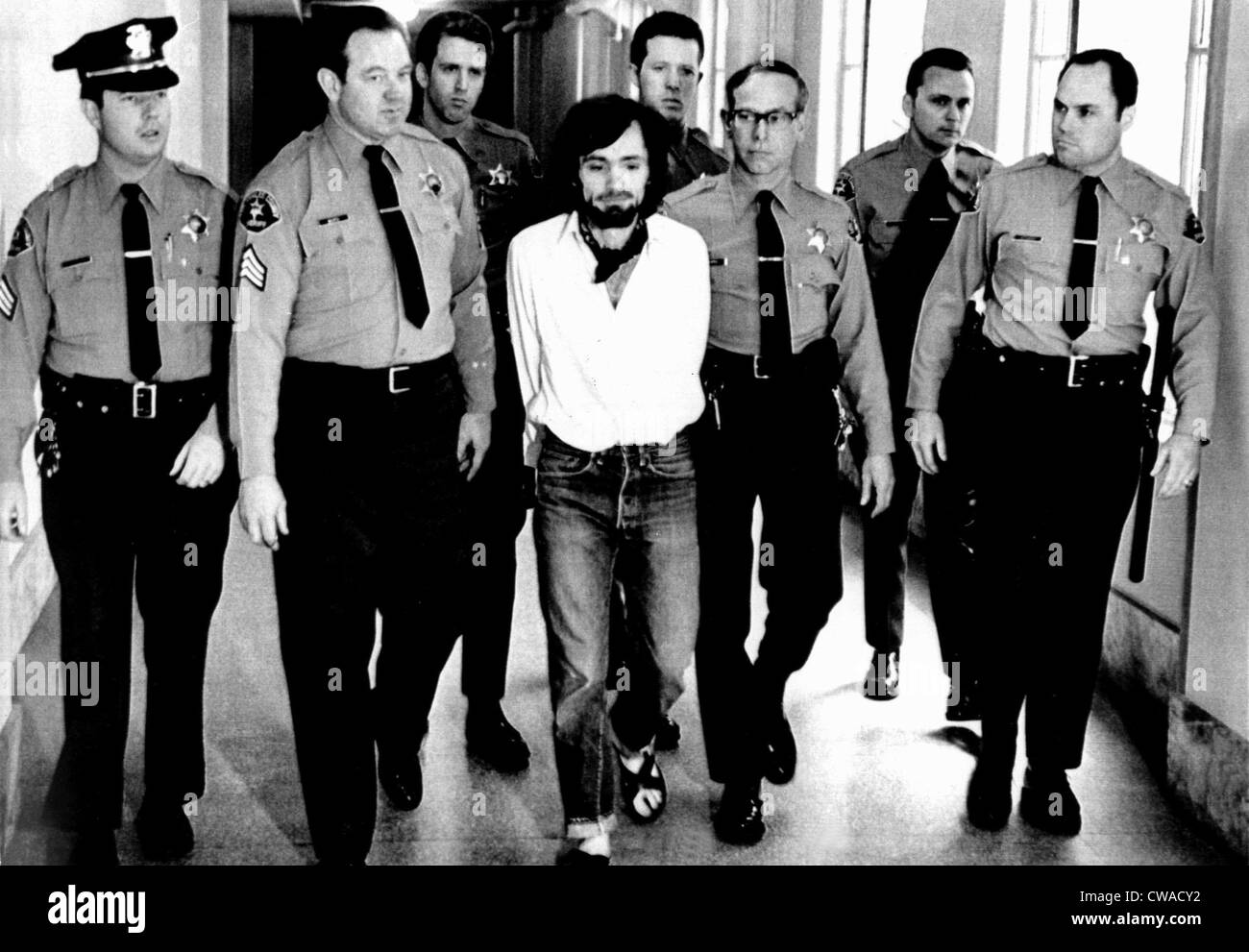 Charles Manson, 1971, being led away in handcuffs after being found guilty of murder. Courtesy: CSU Archives / Everett Stock Photo
