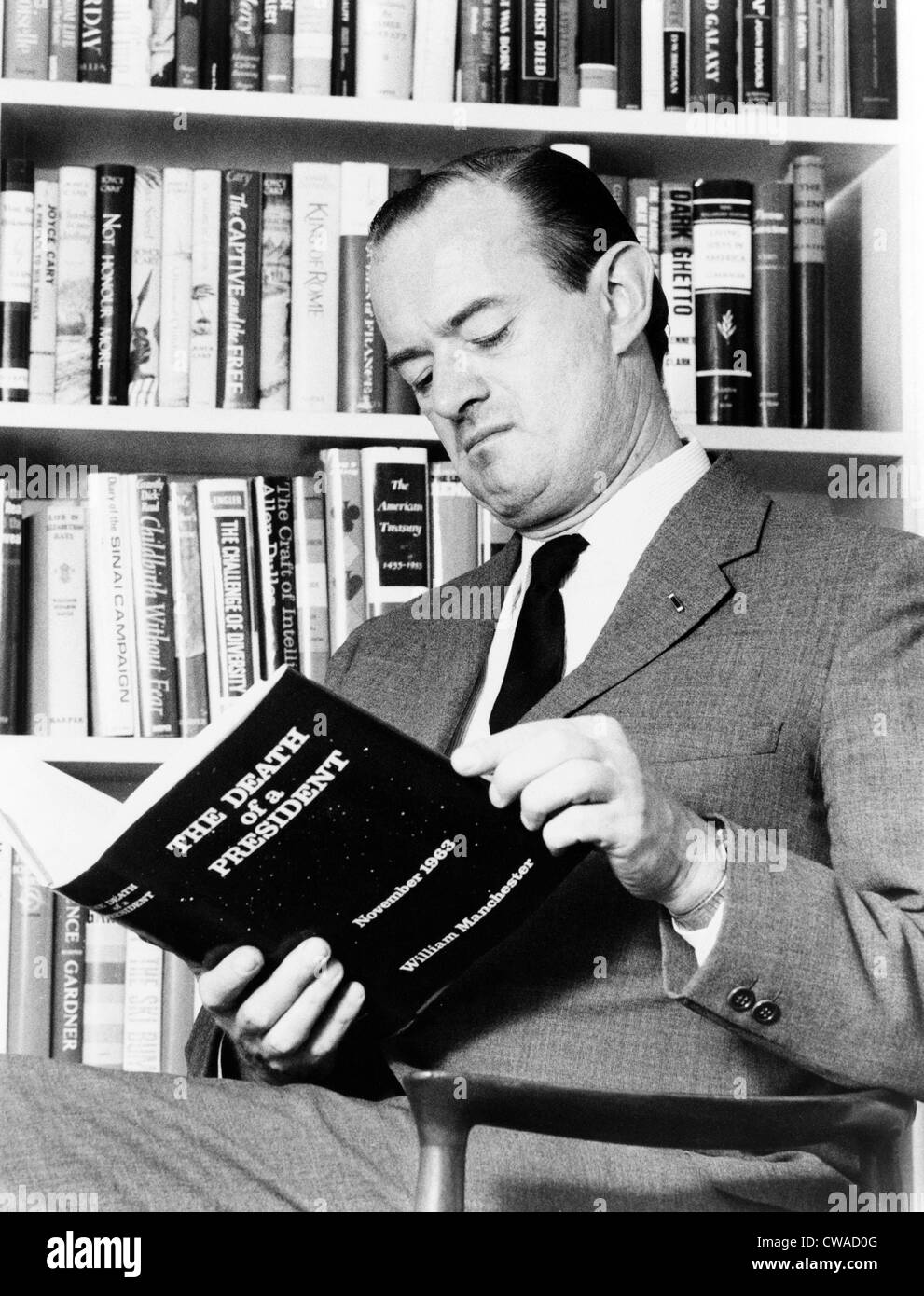 William Manchester (1922-2004), American biographer and historian, holding a copy of his book, 'The Death of a President,' one Stock Photo
