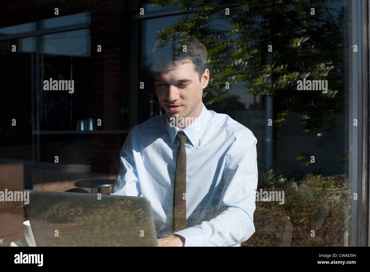 Businessman in cafe, view through window Stock Photo