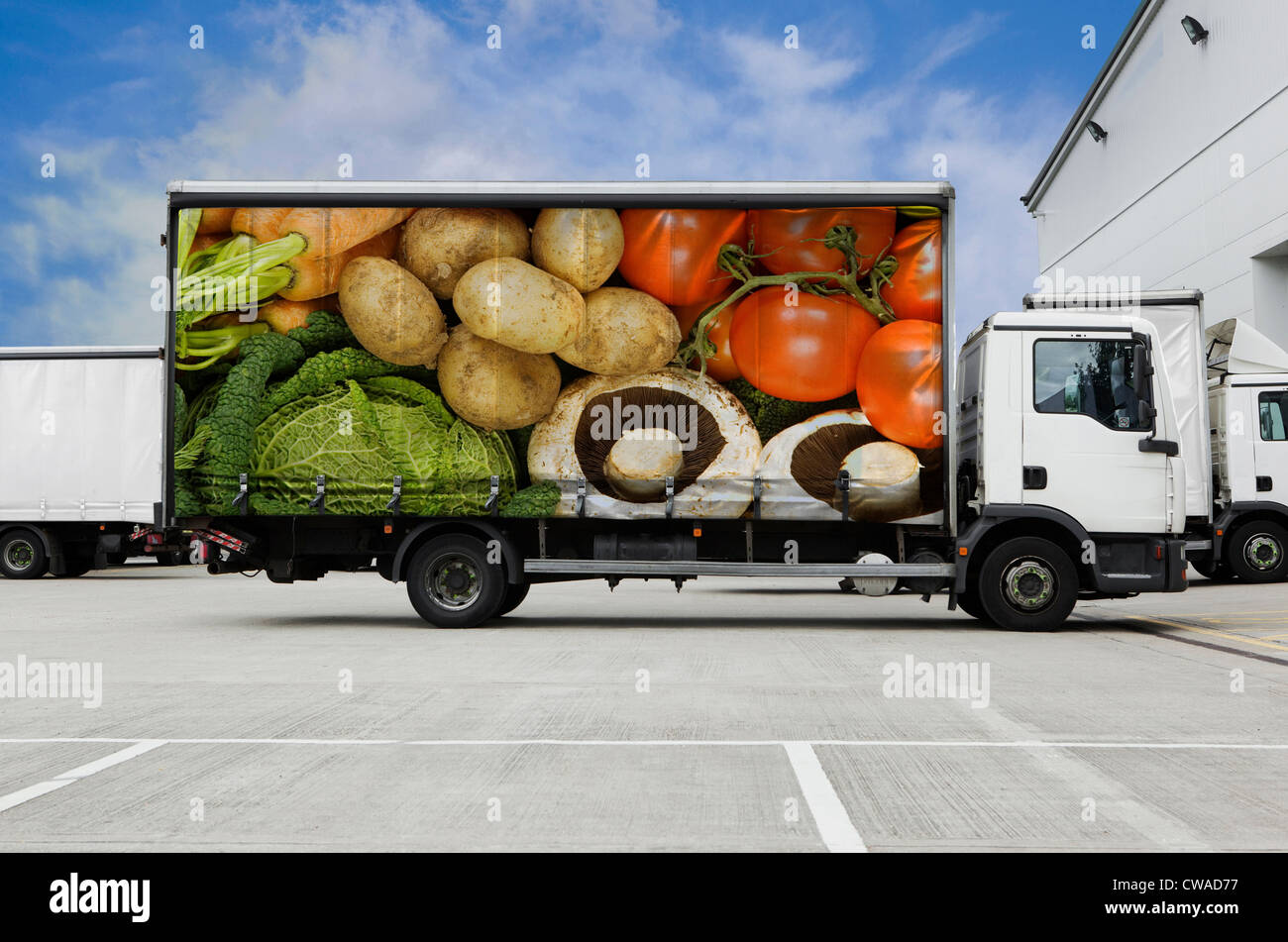 Truck with vegetables parked outside distribution warehouse Stock Photo
