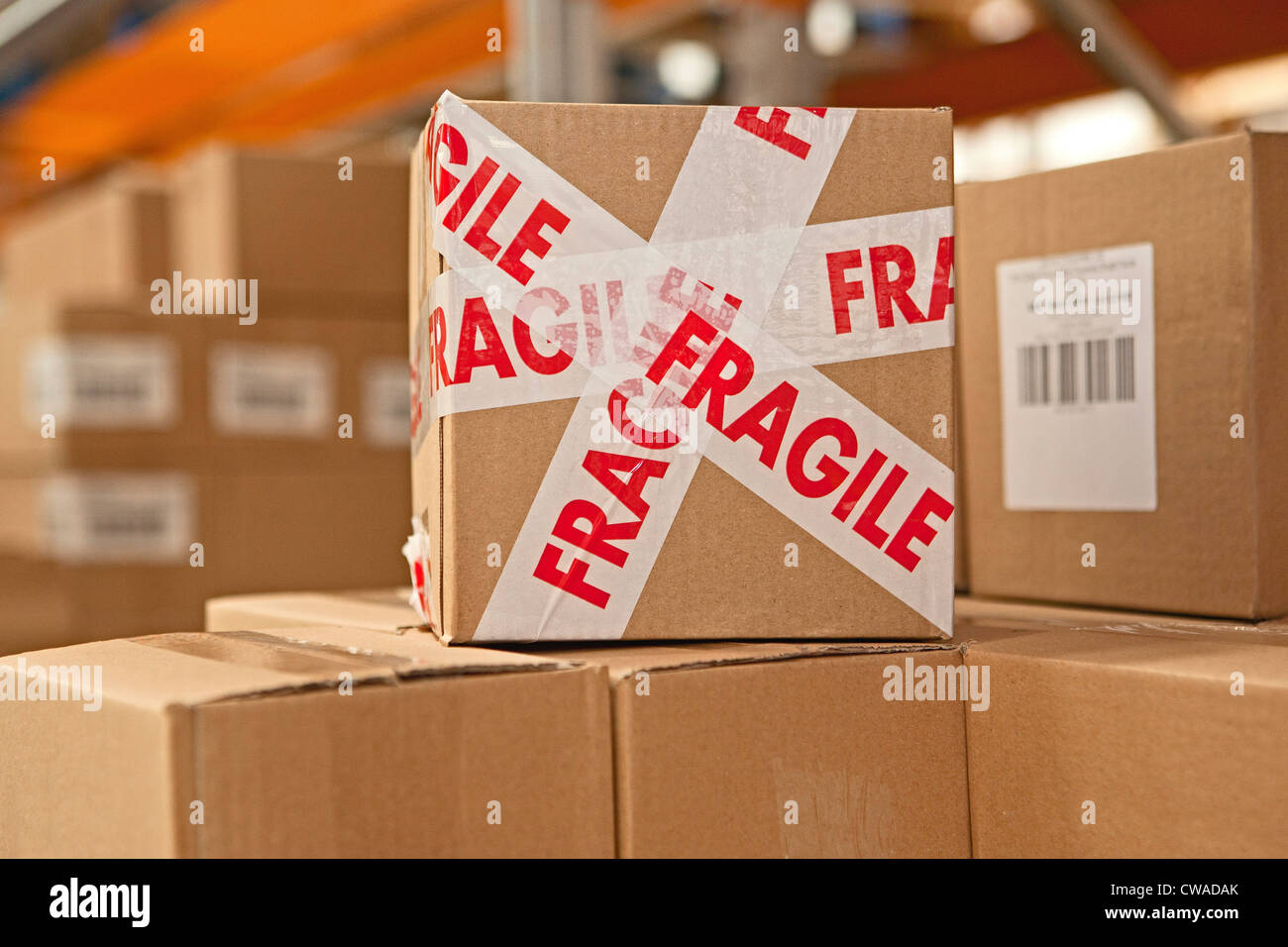 Cardboard box with parcel tape saying fragile Stock Photo
